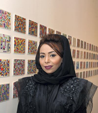 Artist Ebtisam Abdulaziz seen posing with her artworks at the opening day of her solo show tiltled "Autobiography 2012" in Dubai. December 5, 2012. Photo by Ashok Verma