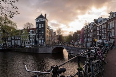 Bicycles rest on bridge railings beside Prince's Canal in Amsterdam, Netherlands, on Monday, March 25, 2019. Amsterdam is the latest European city to try to get a grip on its buy-to-let housing market as it seeks to stop a wave of landlords from capitalizing on booming property prices. Photographer: Geert Vanden Wijngaert/Bloomberg