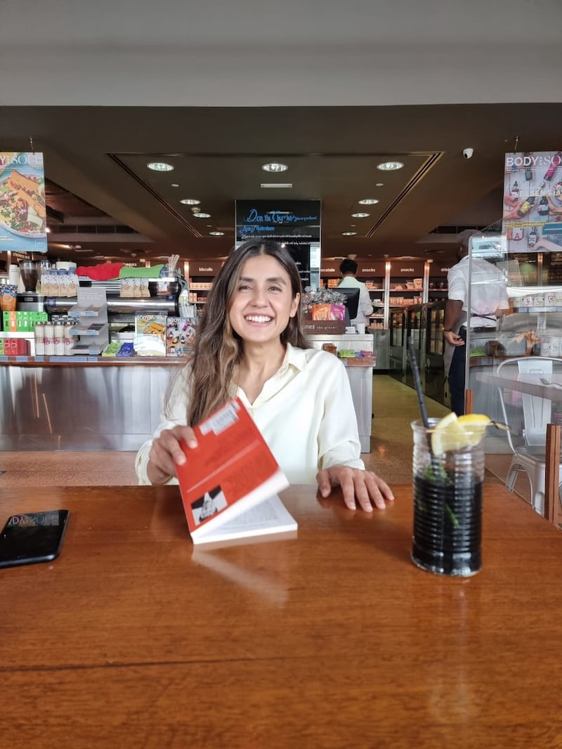 Sarah pictured in a cafe in Abu Dhabi. Her friends have been shocked by her death. Photo: Inam Family