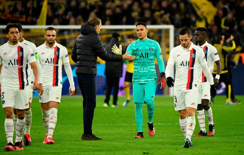 Thomas Tuchel (C-L) shakes hands with PSG goalkeeper Keylor Navas at the end of the match. AFP