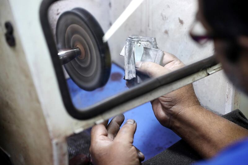 SHARJAH , UNITED ARAB EMIRATES , OCT 24   – 2017 :- One of the worker polishing the silver jewellery at the Al Baroon silver shop in the Al Mareija area near the Heritage area in Sharjah. They are in the jewellery business for the last 30 years. (Pawan Singh / The National) For Weekend