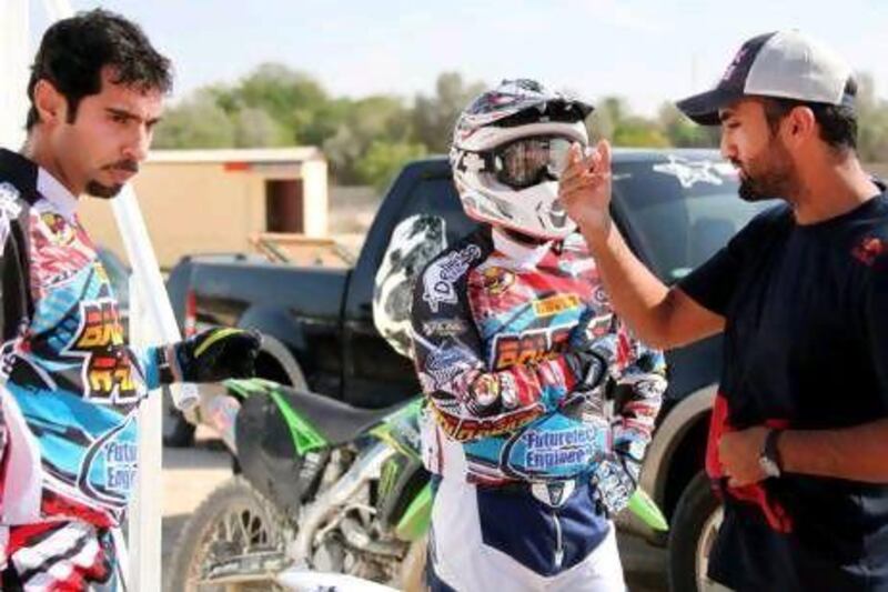Mohammed Al Balooshi briefs his teammates about the DMX Motocross track.