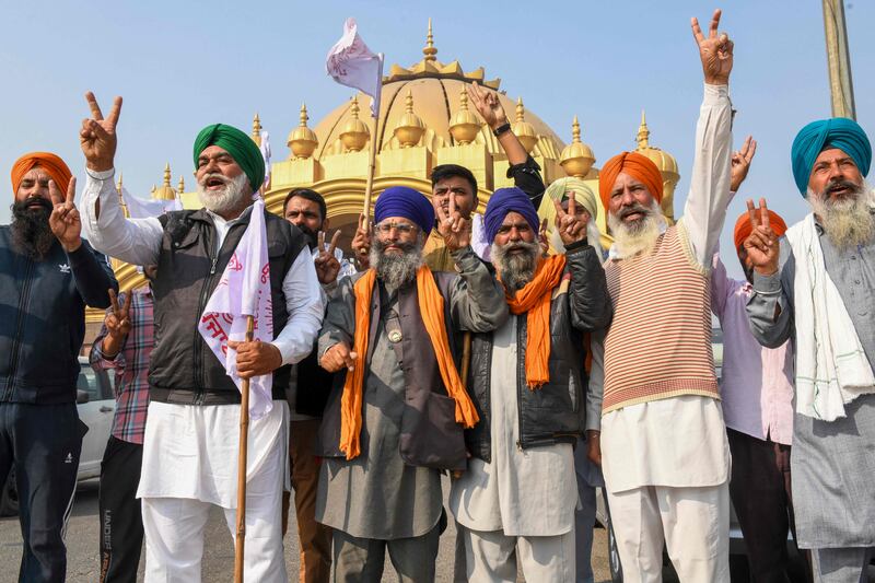 Farmers in Amritsar celebrate after India's prime minister announced the decision to repeal three agricultural reform laws that sparked more than a year of protests across the country. AFP