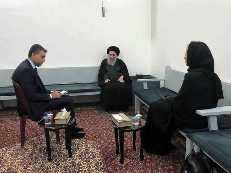 This handout photo from the office of Grand Ayatollah Ali al-Sistani shows Iraq's top Shiite cleric Grand Ayatollah Ali al-Sistani, center, meeting with U.N. envoy to Iraq Jeanine Hennis-Plasschaert, right, in Najaf, Iraq, Sunday, Sept. 13, 2020. In a statement released by his office after meeting the U.N. envoy Al-Sistani threw his support behind the prime ministerâ€™s announcement to hold parliamentary elections ahead of schedule next year, a key demand of protesters. (Office of Grand Ayatollah Ali al-Sistani, via AP)