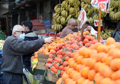 People buy fruit and vegetables in Cairo. Egypt's economy is contracting due to the record inflation which has driven down consumption. EPA