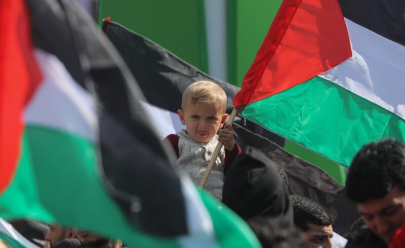A Palestinian boy holding a flag of Palestine attends with his father a protest against US President Trump's so-called 'Deal of the Century' aimed at solving the conflict between Palestinians and Israel, in the streets of Gaza City, Gaza Strip.  EPA