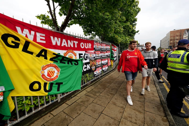 Fans walk to the Old Trafford ground ahead of an organised protest against the Manchester United owners. PA