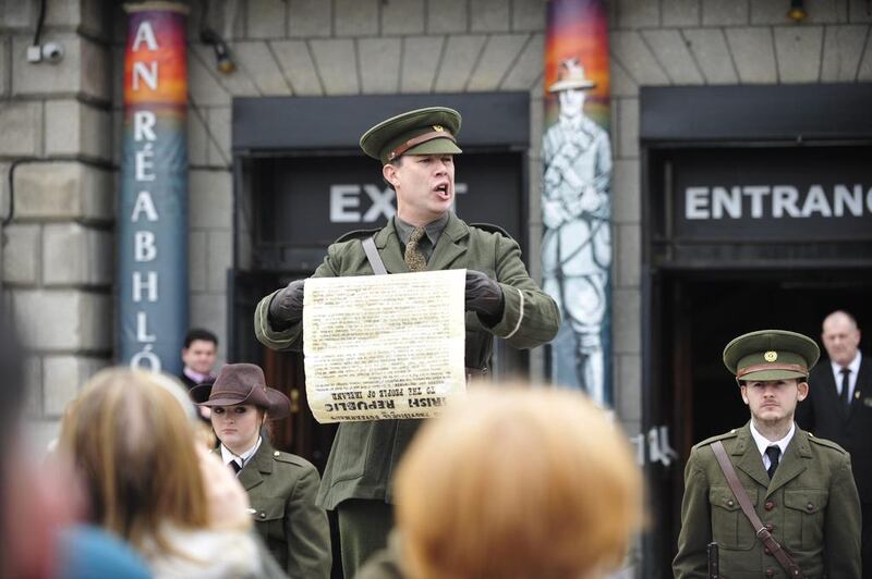 An actor posing as Irish Rebel leader Padraig Pearce reads the 1916 proclamation to tourists in Dublin, Ireland. Aidan Crawlet / EPA 