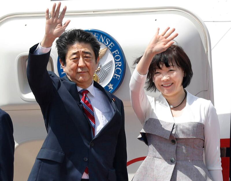 Japanese Prime Minister Shinzo Abe, left,  waves with his wife Akie Abe while boarding his plane before departure for the Middle Eastern countries, at Haneda international airport in Tokyo Sunday, April 29, 2018. Yukie Nishizawa / Kyodo News via AP