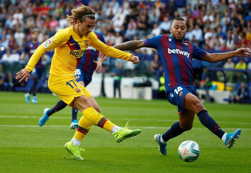 Barcelona's Antoine Griezmann vies for the ball with Levante's Ruben Vezo in Valencia. Reuters