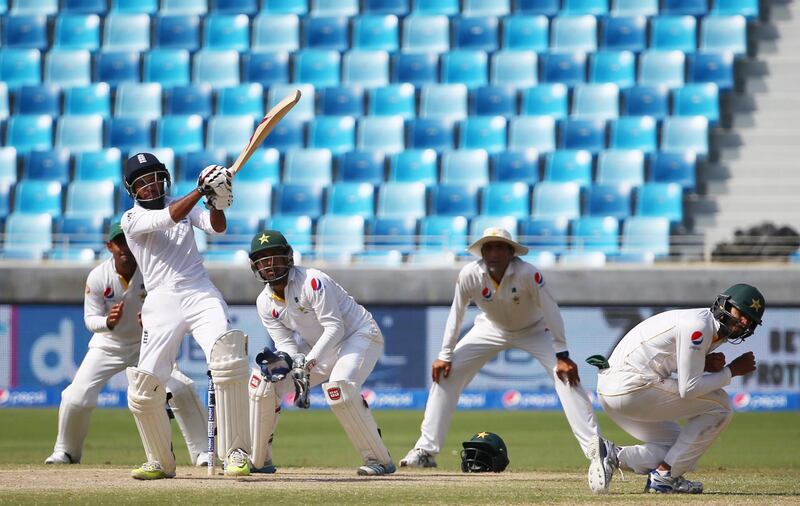 England's Adil Rashid plays a shot during the fifth and last day of the second Test cricket match between Pakistan and England in Dubai on October 26, 2015. AFP PHOTO / MARWAN NAAMANI (Photo by MARWAN NAAMANI / AFP)