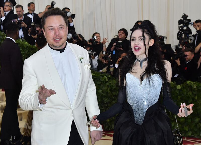 (FILES) In this file photo taken on May 7, 2018 Elon Musk and Grimes arrive for the 2018 Met Gala, at the Metropolitan Museum of Art in New York. Fans hoping for clarity and perhaps some pronunciation tips were left floundering on Mya 6, 2020 after Elon Musk's girlfriend, the musician Grimes, explained their newborn son's name -- X Æ A-12. Musk, the outspoken Tesla chief, announced the birth of the couple's first child earlier this week, before Grimes broke down the unusual moniker.
 / AFP / ANGELA WEISS
