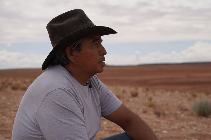 Franklin Martin, a Navajo rancher, looks out at a dry earth dam in the Bodaway area of the Navajo Nation reservation.