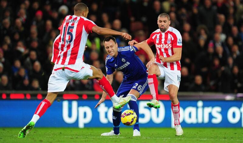 Chelsea player John Terry  (c) is challenged by Jonathan Walters (r) and Steven Nzonzi during the Barclays Premier League match between Stoke City and Chelsea at Britannia Stadium on December 22, 2014 in Stoke on Trent, England.  (Photo by Stu Forster/Getty Images)