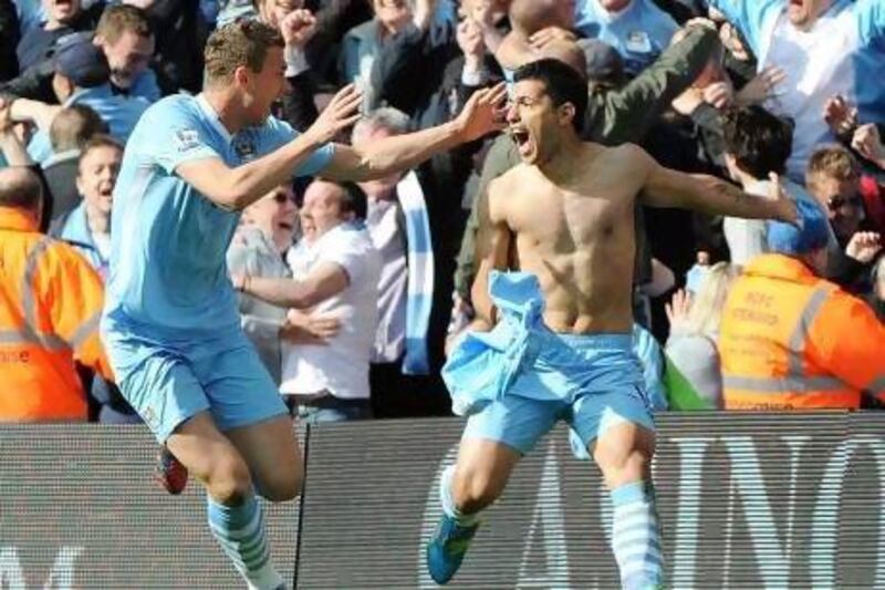 Sergio Aguero, right, and Edin Dzeko celebrate the winning goal just when it seemed everything was lost.