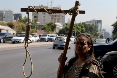 Protesters carry a mock gallows outside a military court during the hearing for Amer Fakhoury in Beirut, Lebanon. Reuters