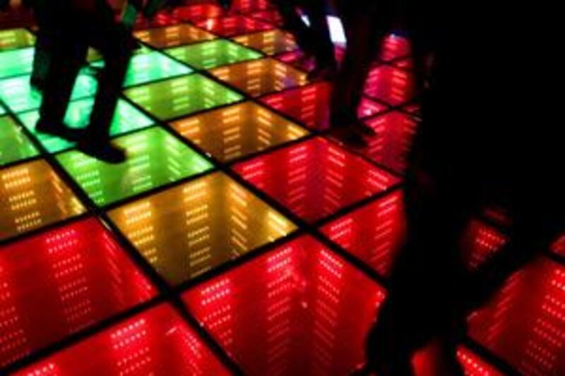 Dancers at club WATT in Rotterdam produce the energy for the lights of the dance floor as they stomp their feet. WATT is one of a number of venues around the world embracing the concept of green clubbing.