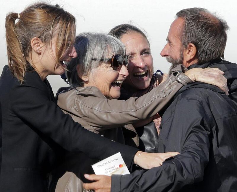 Freed French hostage Daniel Larribe, right, is welcomed home by relatives at Villacoublay military airport, near Paris. Jacky Naegelen / Reuters
