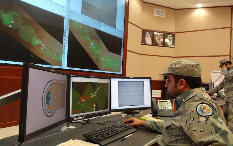 Saudi border guards monitor cameras and radars on surveillance screens at the Arar regional command and control centre headquarters. AFP