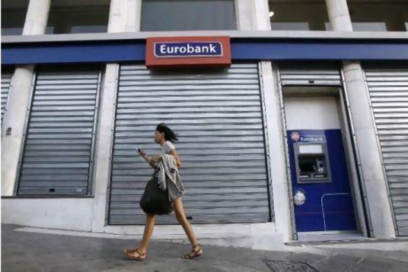 European banks are sitting on a mountain of government debt. Above, a closed branch of Eurobank in Athens.