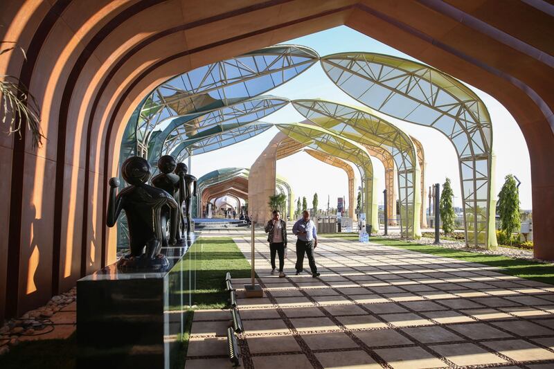 Attendees pass sculptures in the grounds of the green zone area at Cop27. Bloomberg