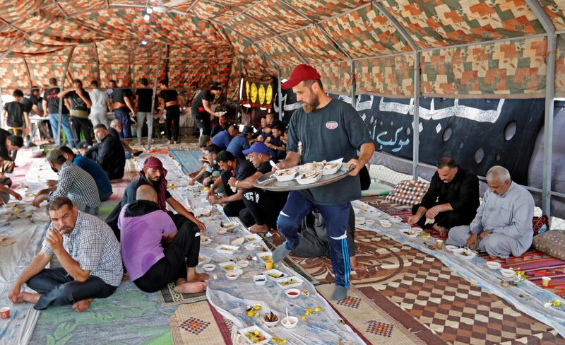 An Iraqi volunteer, Sattar Al Souaidi, serves food to Shiite Muslim pilgrims as they walk to the holy city of Kerbala ahead of the ritual of Arbaeen.  Reuters