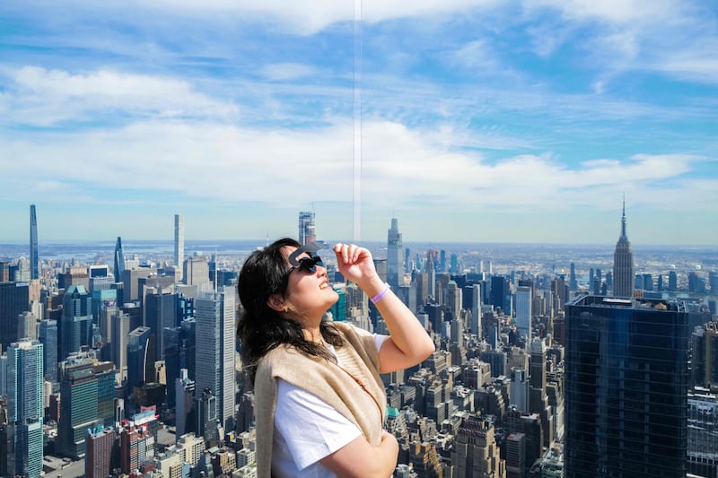 A woman looks skyward at the Edge at Hudson Yards observation deck in New York City. AFP