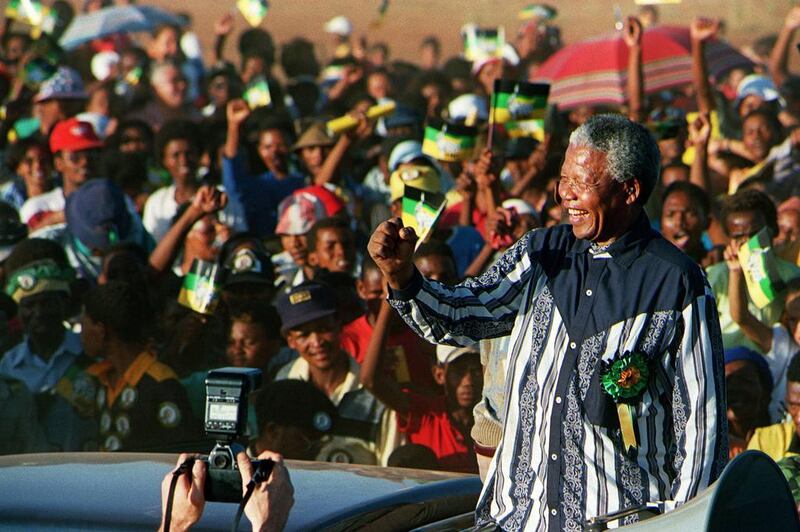 February 24, 1994, Mandela waves to the crowd as he enters Roodepan township in Kimberley during an electoral meeting. Guy Tillim / AFP Photo
