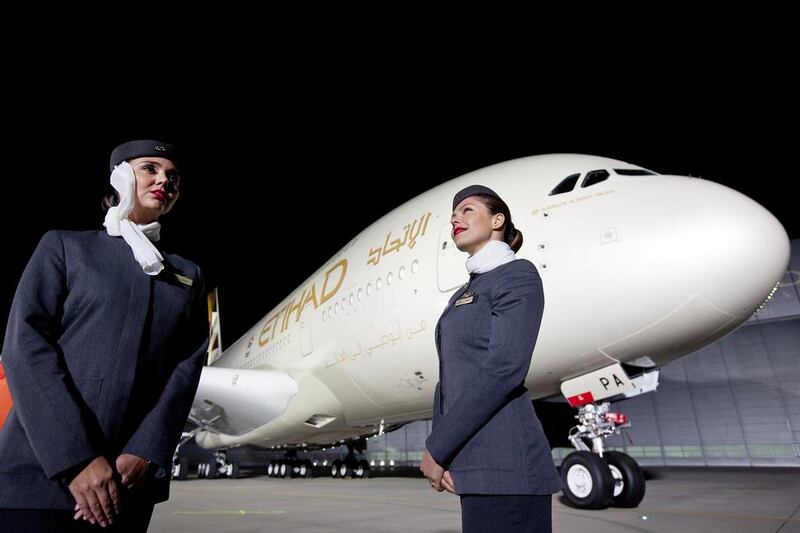 Cabin crew pose with Etihad Airways' first Airbus A380 which was rolled off in Hamburg in September last year. Roland Magunia for The National