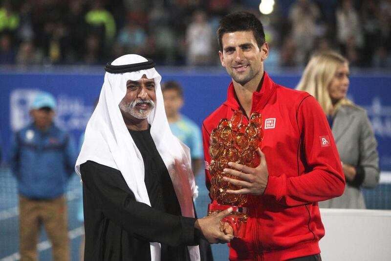 Novak Djokovic accepts the first place trophy from Sheikh Mubarak Al Nahyan Mubadala Tennis Championships at Zayed Sports City. Lee Hoagland / The National