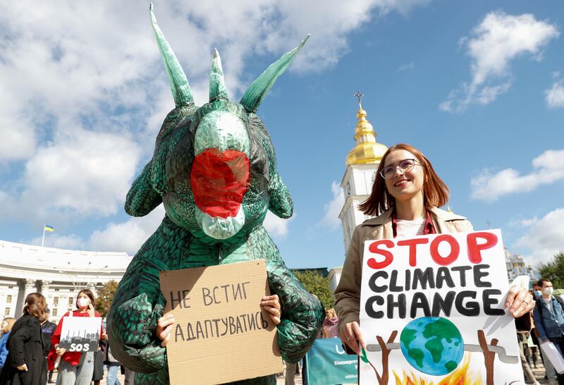 Environmental activists take part in a rally demanding actions to avert climate change in central Kyiv, Ukraine September 26, 2021. More than 600 business leaders around the world are calling on G20 countries to take more decisive climate change action.  Reuters