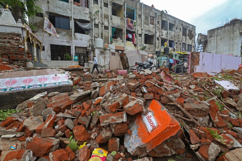 A damaged temple and compound wall of a residential building after the cyclone swept Ahmedabad, Gujarat, India. EPA