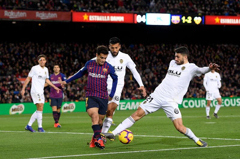 BARCELONA, SPAIN - FEBRUARY 02:  Philippe Coutinho of Barcelona is challenged by Cristiano Piccini of Valencia  during the La Liga match between FC Barcelona and Valencia CF at Camp Nou on February 2, 2019 in Barcelona, Spain.  (Photo by Alex Caparros/Getty Images)