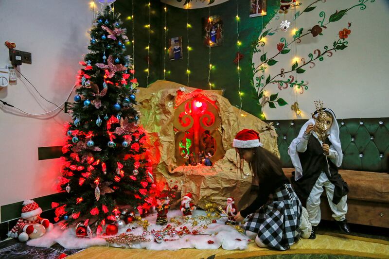 A child decorates her home ahead of Christmas in Al Hamdaniya, Iraq. Reuters