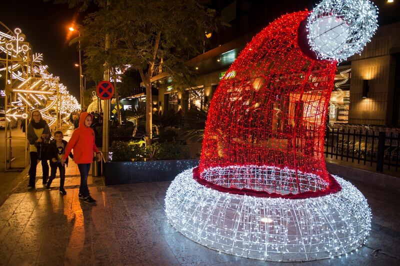 People gather to look at Christmas lights and decorations in fifth settlement district in Cairo, Egypt.  EPA