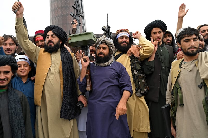 Taliban fighters hold rifles while chanting victory slogans at Ahmad Shah Massoud Square near the US embassy. AFP