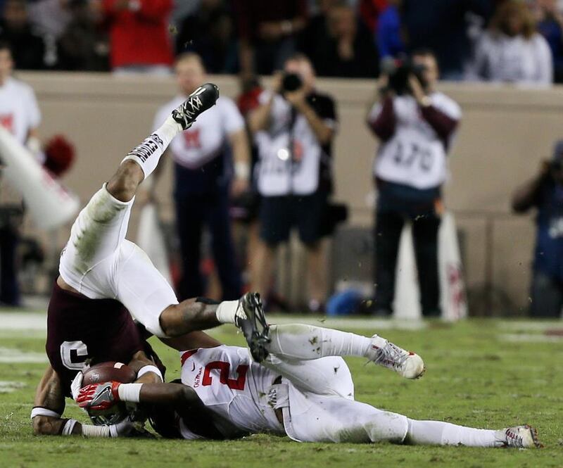 Texas A&M’s Trayveon Williams is tackled by Deontay Anderson of the Mississippi Rebels in the fourth quarter at Kyle Field in College Station, Texas.  Bob Levey / Getty Images / AFP