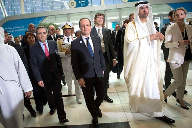 France's President Francois Hollande (C) walks with Sultan Ahmed al-Jaber (C-R), chief executive officer of the Abu Dhabi Future Energy Company (MASDAR) and French Ecology Minister, Delphine Batho (R), during a tour of the opening ceremony of the World Future Energy Summit (WFES) at the Abu Dhabi National Exhibitions Centre (ADNEC) in the Emirati capital on January 15, 2013. AFP PHOTO/BERTRAND LANGLOIS

