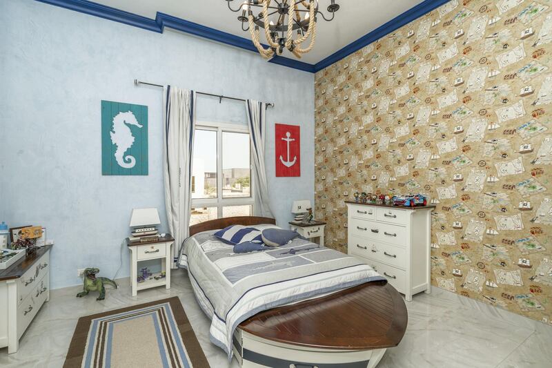 Kids will be quick to drop anchor in this maritime themed bedroom. Courtesy LuxuryProperty.com