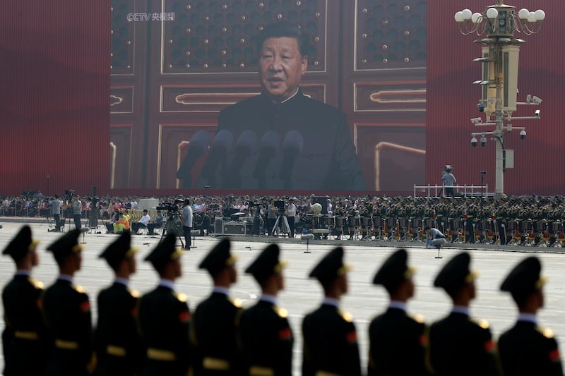 A huge screen shows Chinese President Xi Jinping delivering a speech at the start of a parade to mark the 70th anniversary of the founding of the People's Republic of China. AP Photo