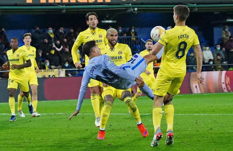 Barcelona's Philippe Coutinho, centre, attempts an overhead kick. AP Photo