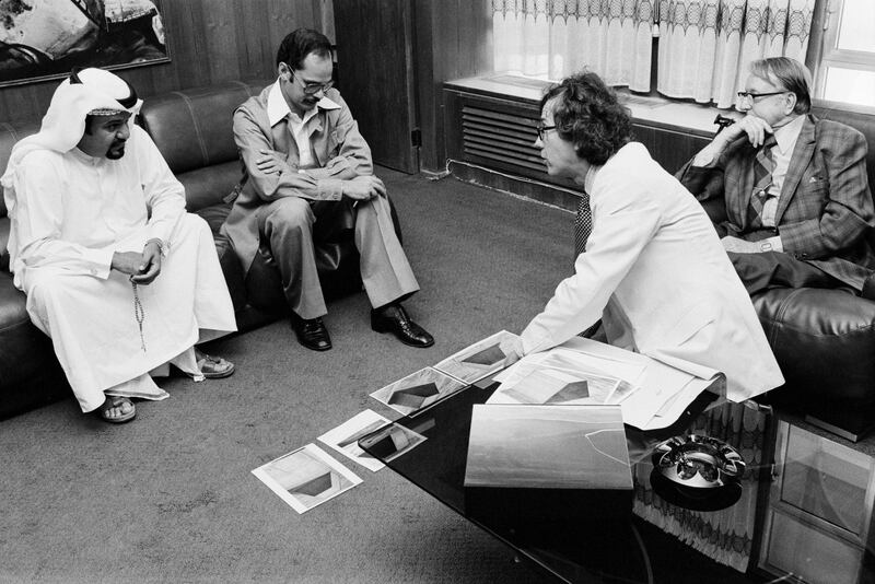 Christo, in the white suit, explaining the preliminary engineering concept for The Mastaba to officials of the Ministry of Construction. The man seated next to the dishdasha guy is Azmi Abu Taleb, Municipal Town Planning Architect.) Photo: Wolfgang Volz, ©Christo.