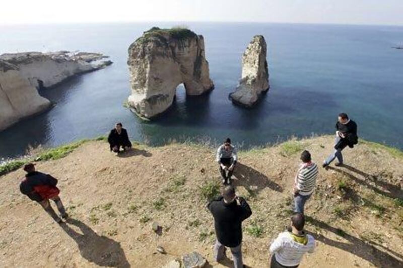 Tourists visit Pigeons Rock in the Rawcheh area of Beirut. Moody's cut its outlook on Lebanon's credit rating to negative from stable. AP