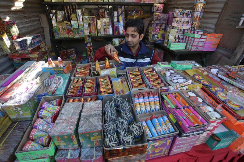 An Indian man displays firecrackers for sale at a shop for the upcoming Diwali festival in Jammu.  EPA