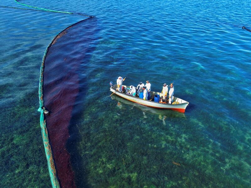 A drone image shows fishermen on a boat as they volunteer near the area where the bulk carrier ship MV Wakashio, belonging to a Japanese company but Panamanian-flagged, ran aground on a reef, at Riviere des Creoles, Mauritius. REUTERS