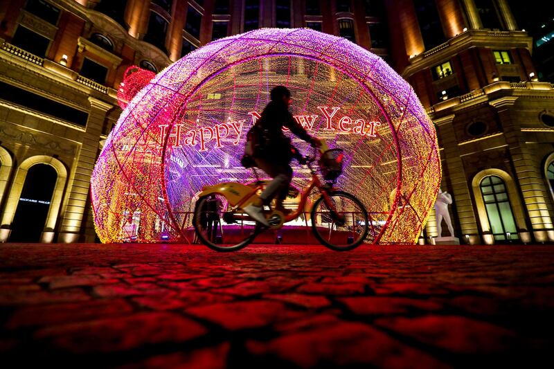A cyclist drives past a giant Christmas ball decoration on a street in Taipei City, Taiwan. EPA