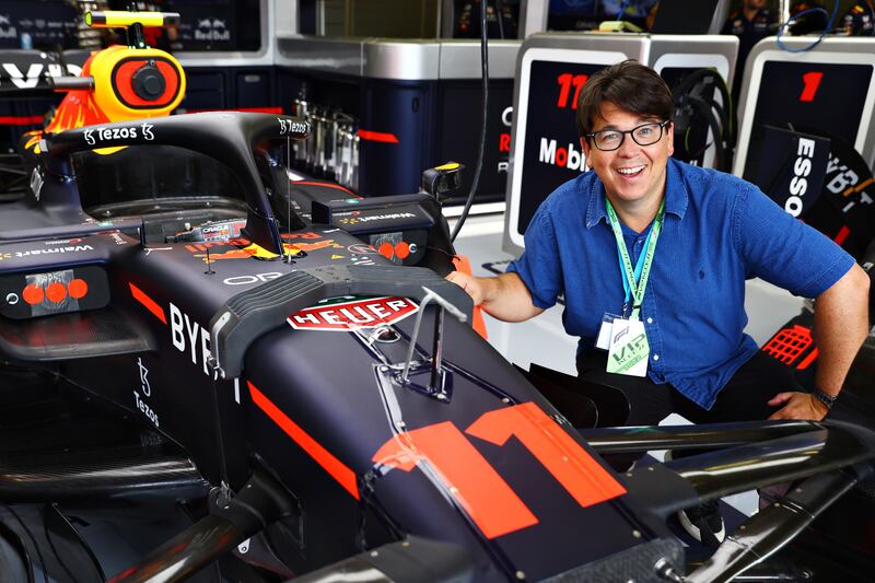 Comedian Michael McIntyre poses for a photo in the Red Bull garage. Getty