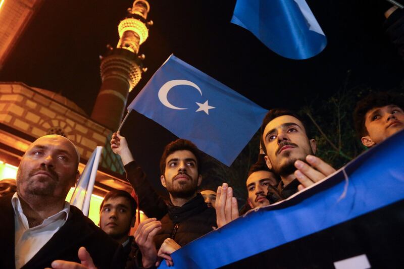 Turkish and Uyghur protestors hold East Turkestan flags during a protest against China in the Turkish capital Ankara..  AFP