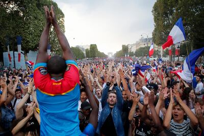 People clap their hands on the Champs Elysees avenue after France won the soccer World Cup final match between France and Croatia, Sunday, July 15, 2018 in Paris. France won its second World Cup title by beating Croatia 4-2 . (AP Photo/Francois Mori)