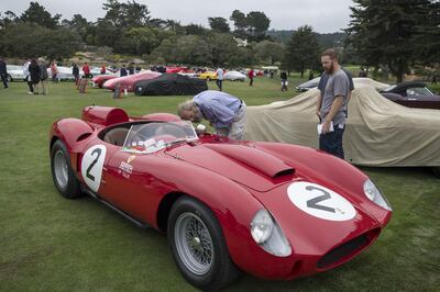 Attendees view a 1958 Ferrari NV 412 S vehicle on display at the Ferrari Concours at the company's special 70th anniversary event during the 2017 Pebble Beach Concours d'Elegance in Pebble Beach, California, U.S., on Friday, Aug. 18, 2017. Official estimates for the Pebble Beach auctions this week have set sales totals at $290 million, down 14 percent since 2016. The downshift in overall sales isn't for lack of funds among buyers, but rather a decrease that comes because classic cars of this caliber are a finite resource. Photographer: David Paul Morris/Bloomberg